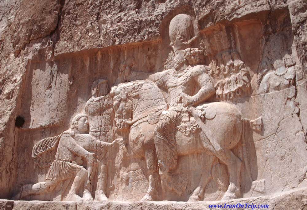 Rock-face relief at Naqsh-e Rustam of Persian  emperor Shapur I on horseback capturing  Roman emperor Valerian standing and Philip  the Arab kneeling suing for peace